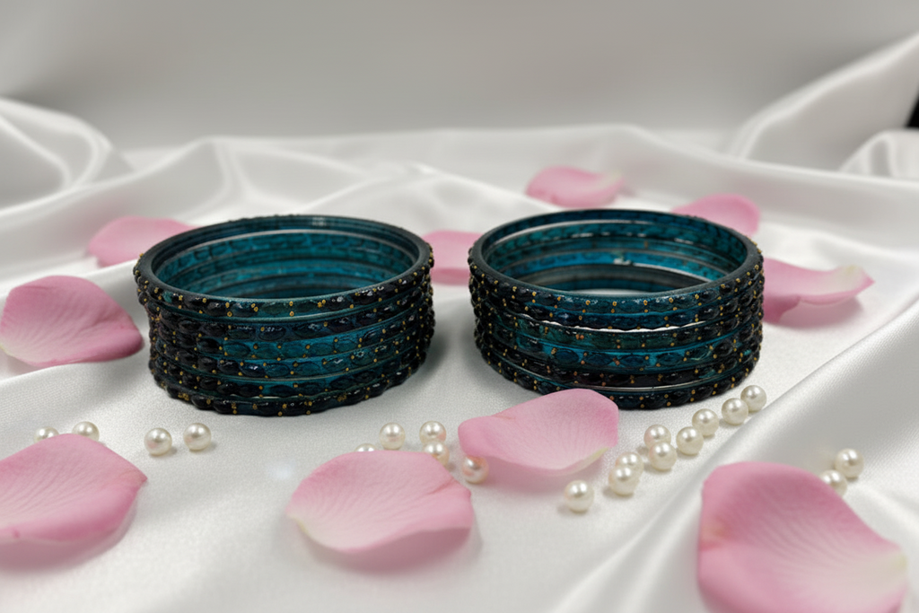 Set of blue ceramic bowls with black speckles on a white background