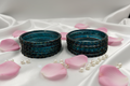Set of blue ceramic bowls with black speckles on a white background